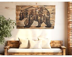 This is a large wood wall hanging featuring a bear and a forest scene. The rustic wall decor is hanging in an entryway over a bench. 